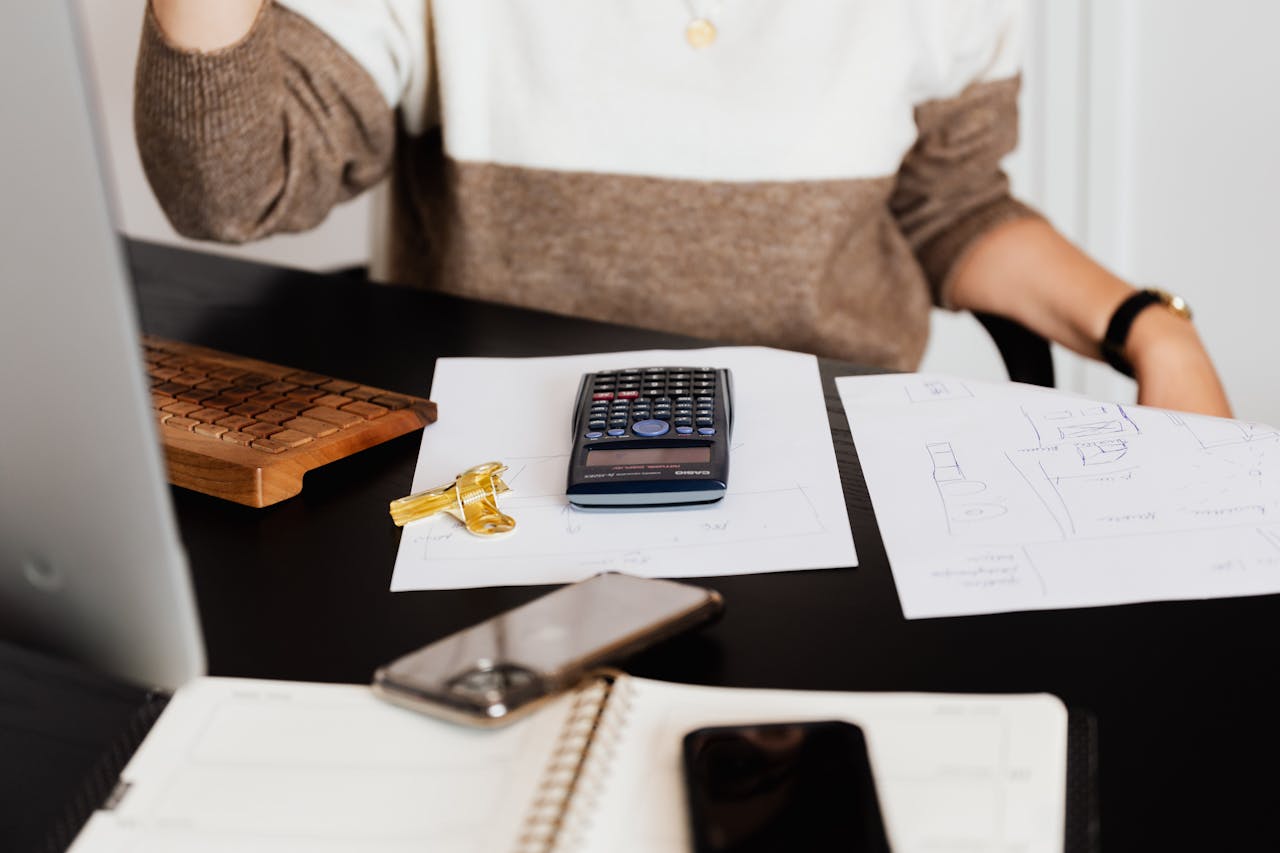 Mastering the First Impression: Your intriguing post title goes here A business desk setup with a calculator, papers, and a keyboard, reflecting a work environment.